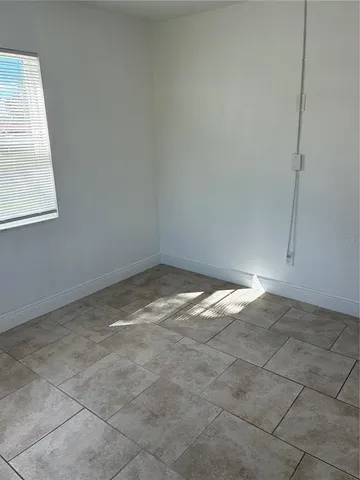 a view of a room with an empty space and window