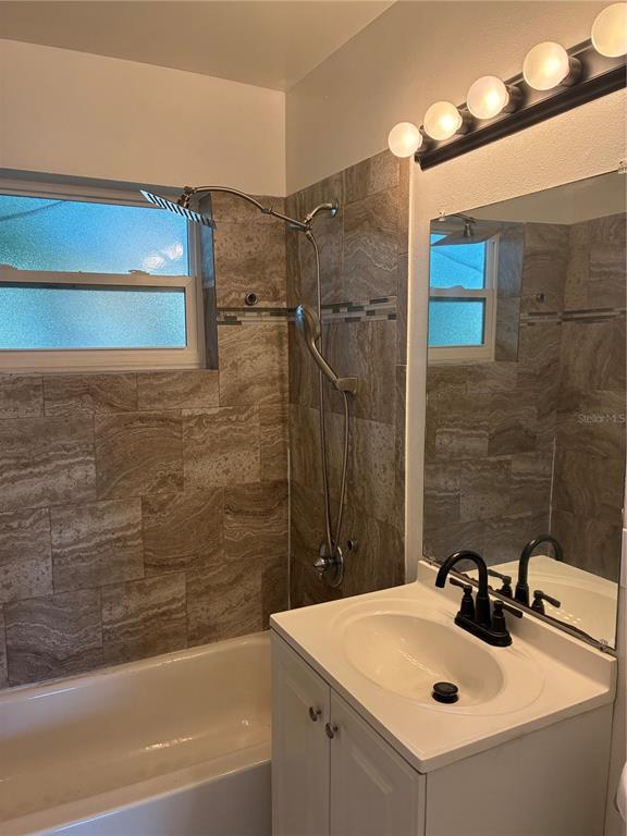 1500 Daroca Drive Deltona, FL 32725 - Photo 10 of 22 a bathroom with a sink and mirror with bathtub