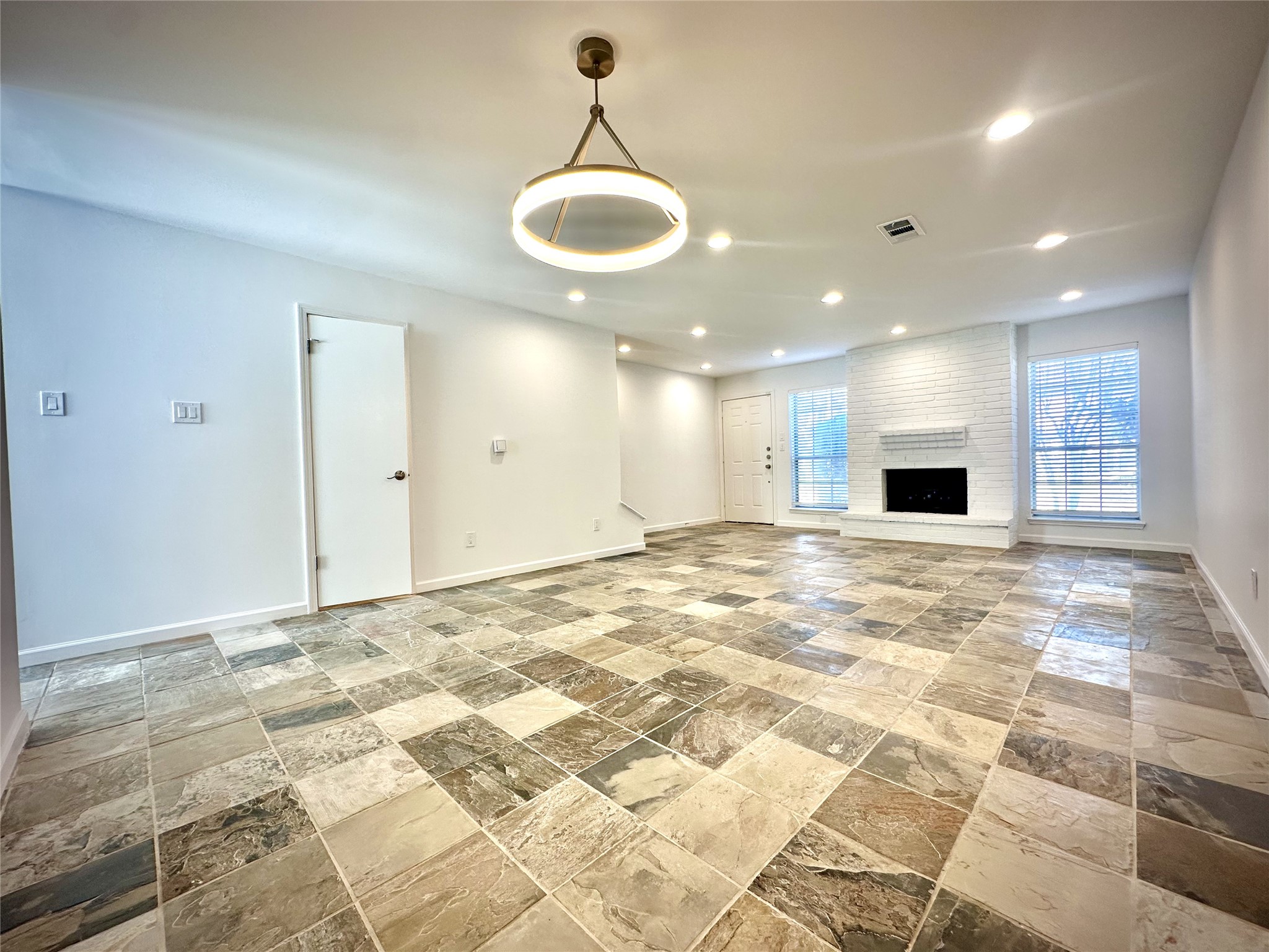 14771 Perthshire Road Houston, TX 77079 - Photo 2 of 23 a view of an empty room with kitchen and chandelier
