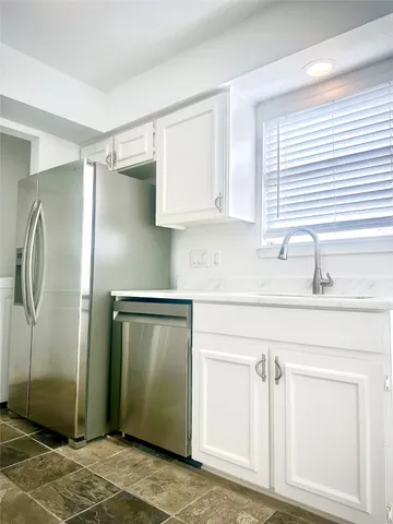 a kitchen with stainless steel appliances cabinets and a counter top space