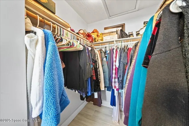 a view of walk in closet with clothes