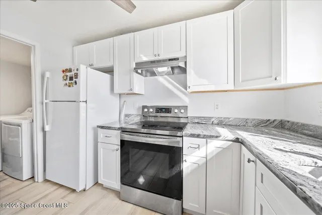 a kitchen with a stove top oven sink and refrigerator
