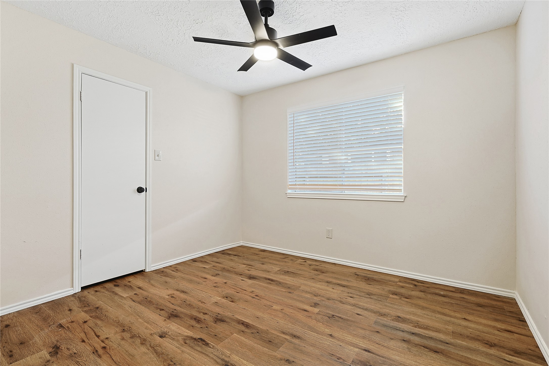 19006 Keyturn Lane Humble, TX 77346 - Photo 11 of 21 a view of empty room with wooden floor and fan