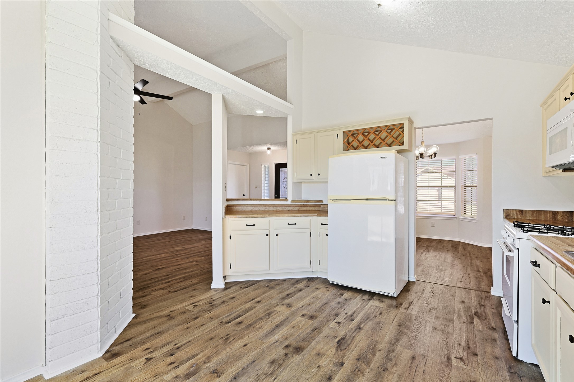 19006 Keyturn Lane Humble, TX 77346 - Photo 9 of 21 a kitchen with a refrigerator and white cabinets