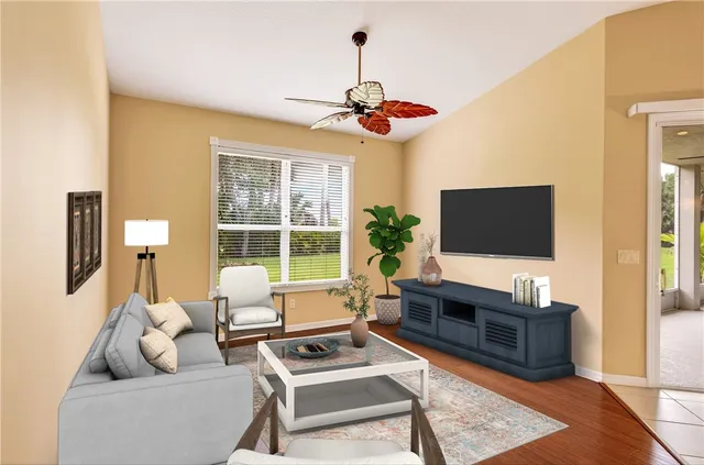 a living room with furniture a flat screen tv and a floor to ceiling window