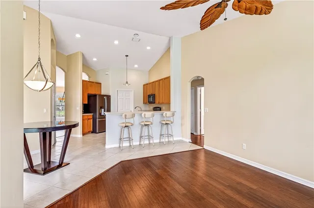 a view of kitchen with refrigerator and window