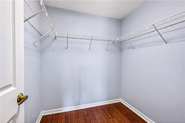 a view of walk in closet with clothes
