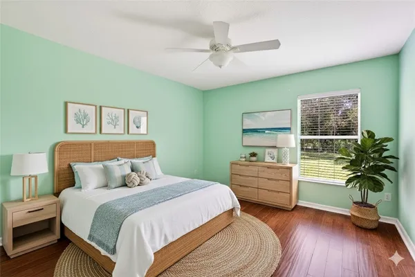 a bedroom with furniture and a wooden floor