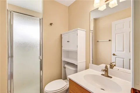 a bathroom with a sink toilet and shower