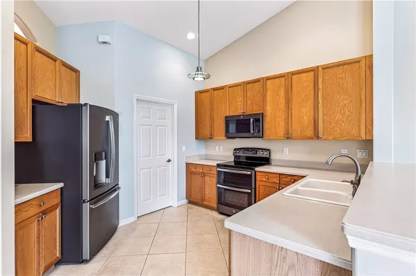 a kitchen with stainless steel appliances granite countertop a refrigerator stove and sink