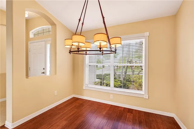 a view of a room with wooden floor and window