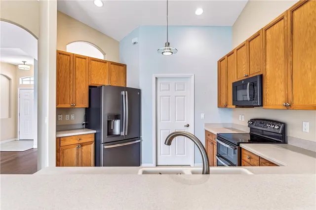 a kitchen with stainless steel appliances a refrigerator a stove a sink and a microwave