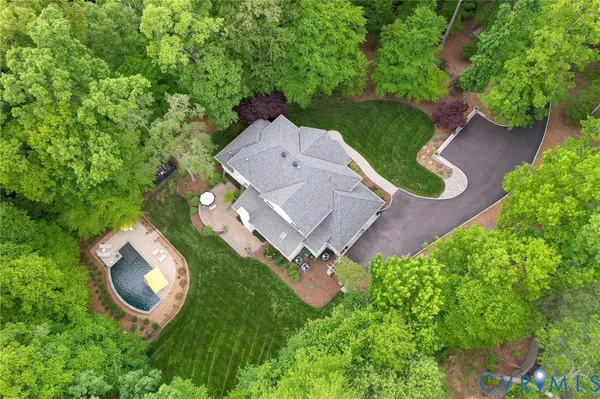 an aerial view of a house with garden space and street view