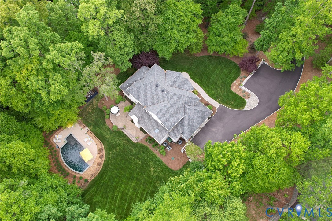 an aerial view of a house with garden space and street view