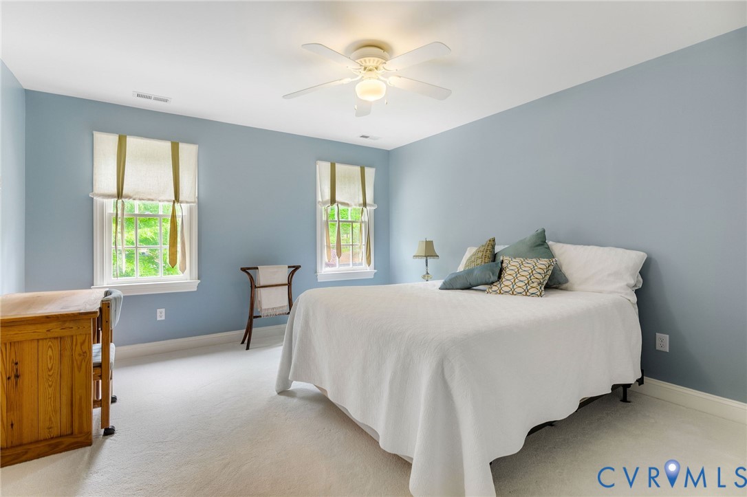 3620 Old Gun Road East Midlothian, VA 23113 - Photo 34 of 56 a bedroom with a bed and a chandelier