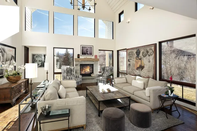 a living room with furniture couches and a fireplace with wooden floor