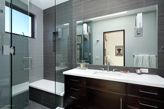 a bathroom with a sink double vanity granite tub and shower