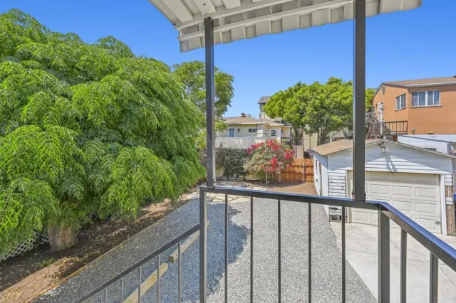 a view of a balcony with an outdoor seating