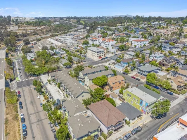 an aerial view of residential houses with outdoor space