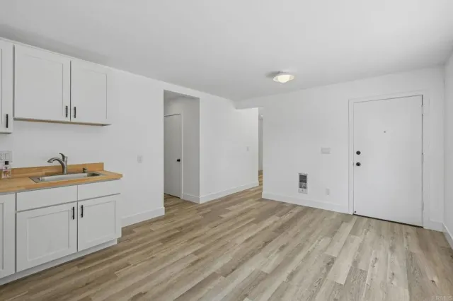 a view of a kitchen with wooden floor