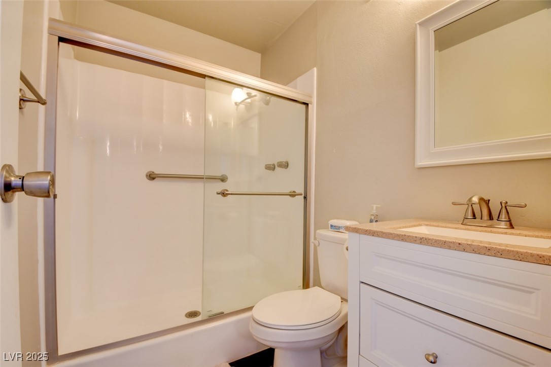 745 North Royal Crest Circle, Unit 127 Las Vegas, NV 89169 - Photo 26 of 26 Bathroom with a stall shower, toilet, and vanity