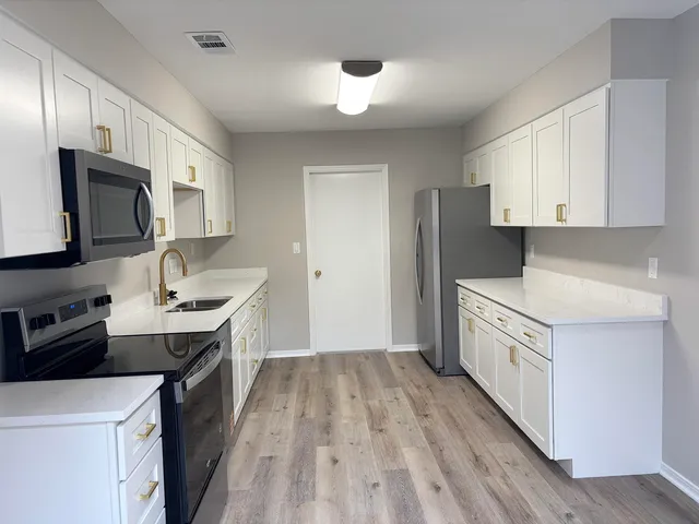 a kitchen with a sink stove and refrigerator