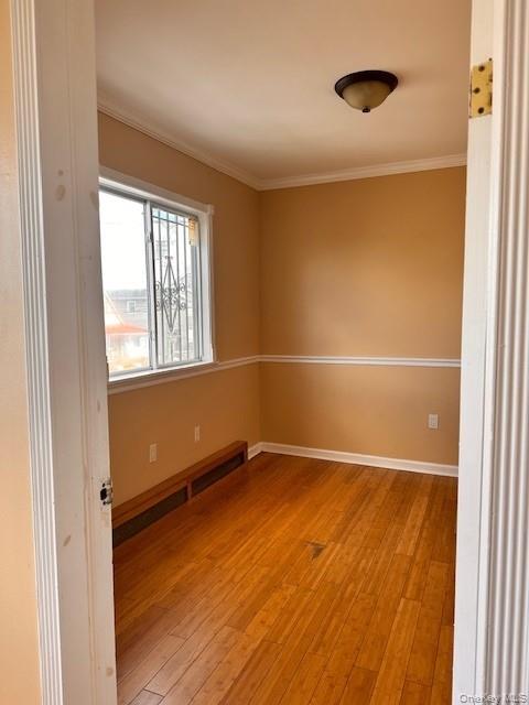 169,34 144th Road Queens, NY 11434 - Photo 6 of 17 a view of an empty room with wooden floor and a window