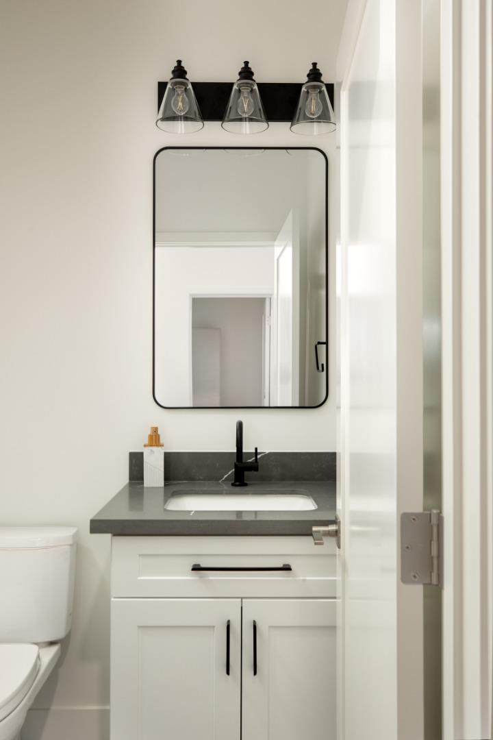 1693 Waterbird Way Sunnyvale, CA 94087 - Photo 14 of 31 a bathroom with a toilet sink and mirror