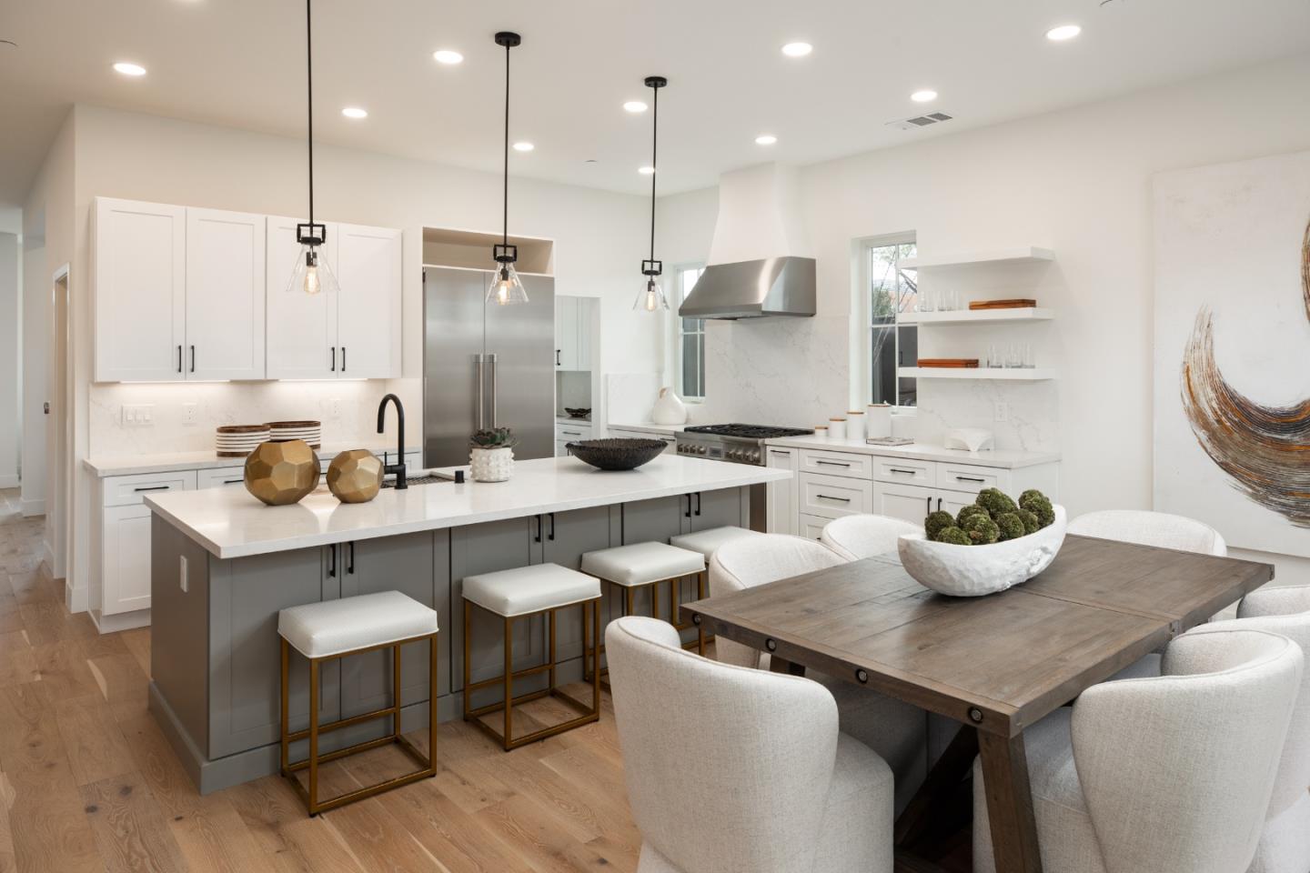1693 Waterbird Way Sunnyvale, CA 94087 - Photo 10 of 31 a kitchen with stainless steel appliances kitchen island granite countertop a sink and white cabinets
