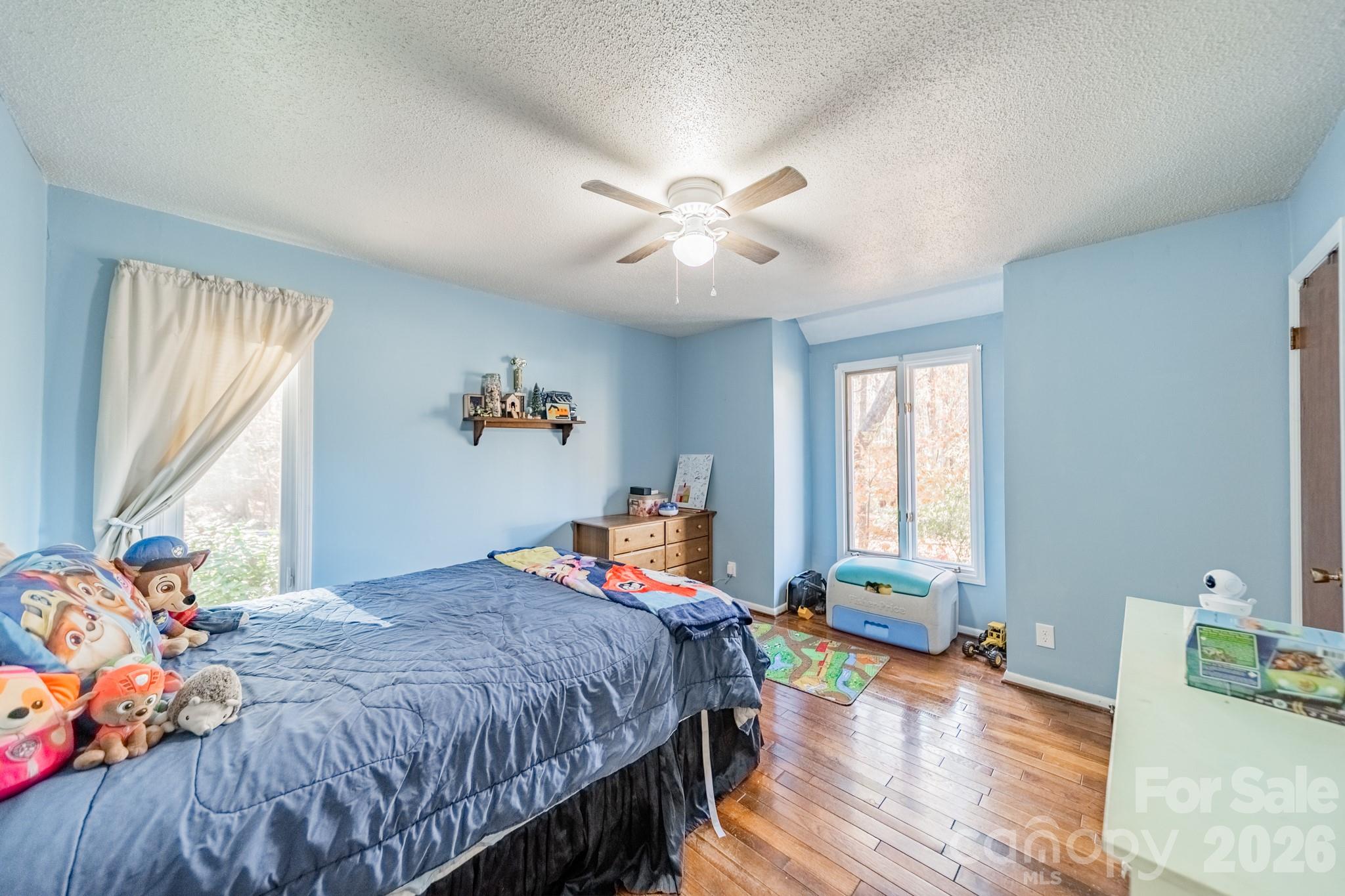 6524 The Little Road Waxhaw, NC 28173 - Photo 7 of 25 a bedroom with a bed and wooden floor