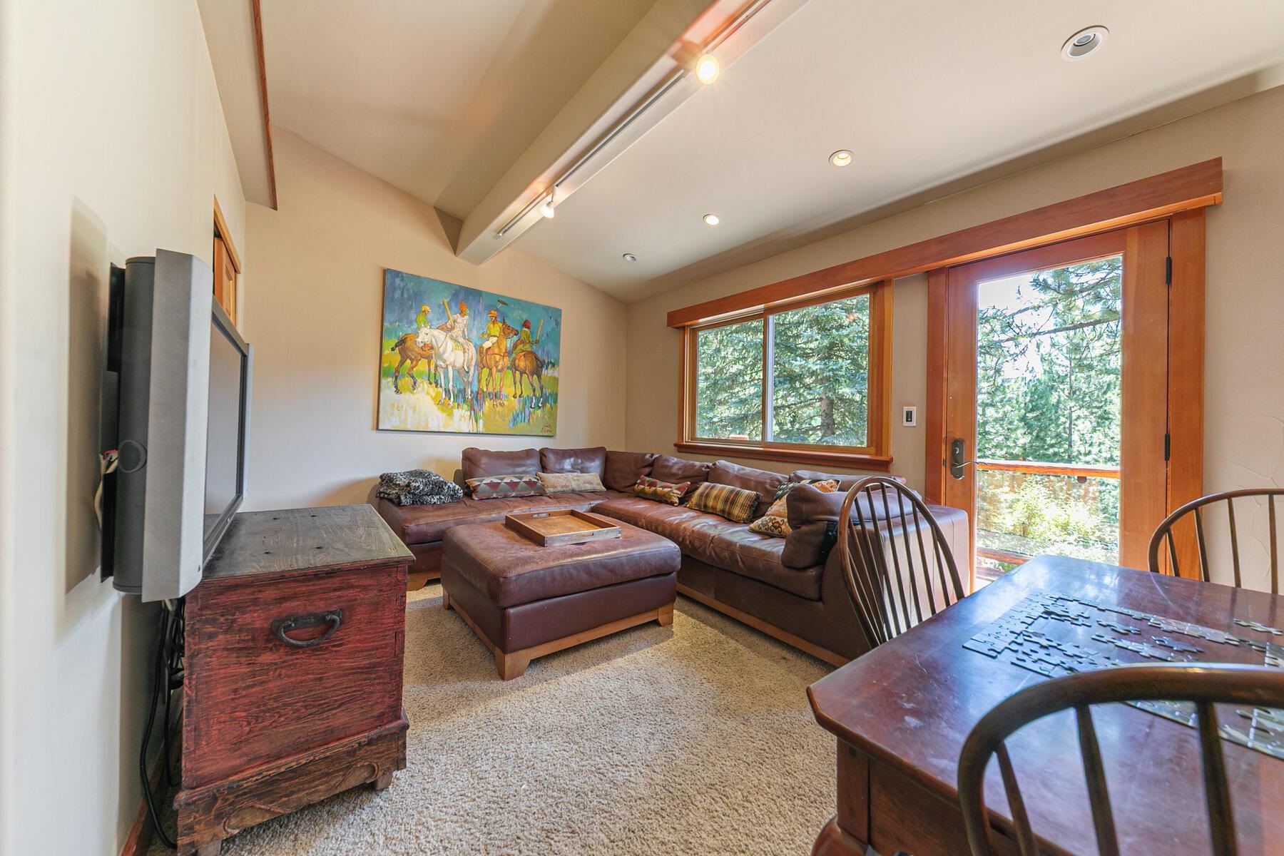1221 Sandy Way Olympic Valley, CA 96146 - Photo 11 of 28 a living room with furniture a large window and a flat screen tv