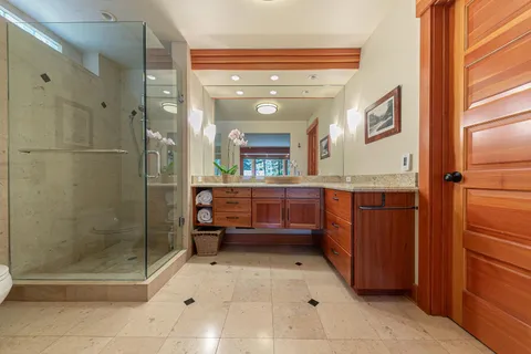 a bedroom with two beds and a large window