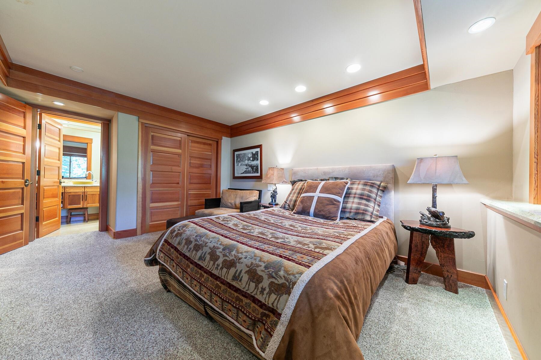 1221 Sandy Way Olympic Valley, CA 96146 - Photo 23 of 28 a spacious bedroom with a bed and a lamp