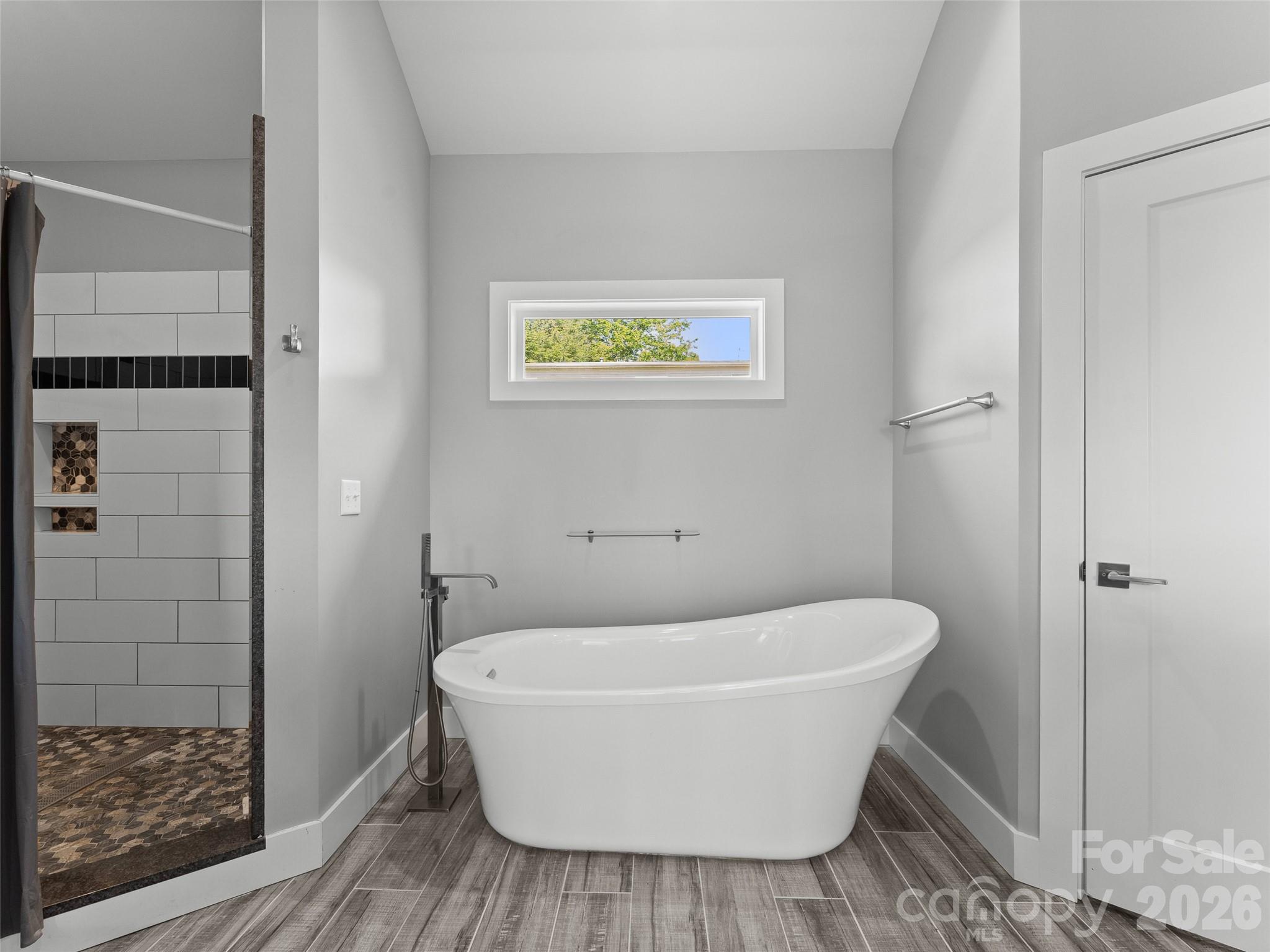 123 Israel Road Candler, NC 28715 - Photo 20 of 44 a white bath tub sitting in a bathroom