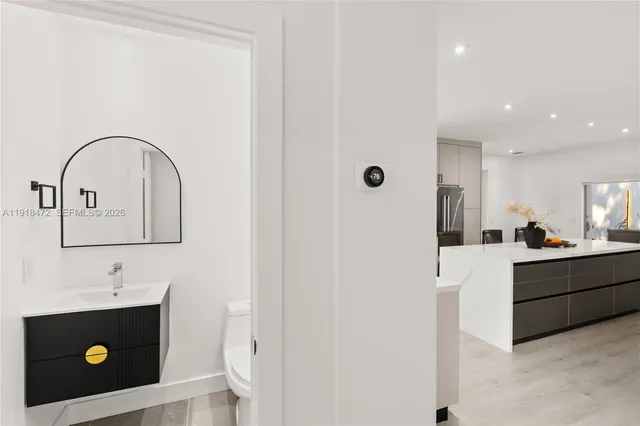 a kitchen with stainless steel appliances sink refrigerator and window