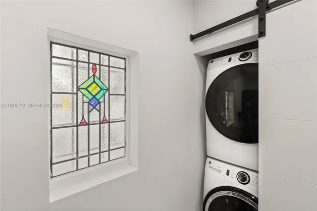 a kitchen with white cabinets and a wooden floor
