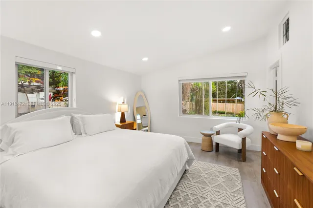 a bedroom with a bed and a painting on the wall