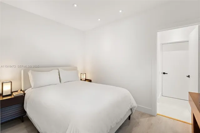 a bedroom with a bed and a night stand