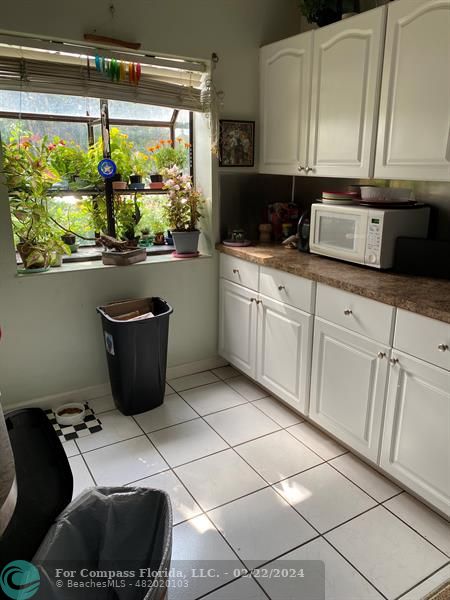a kitchen with a sink a counter top space and a window