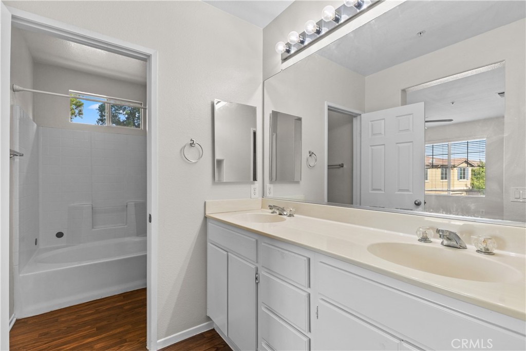 33657 Emerson Way, Unit C Temecula, CA 92592 - Photo 13 of 32 a bathroom with a sink double vanity granite tub and shower