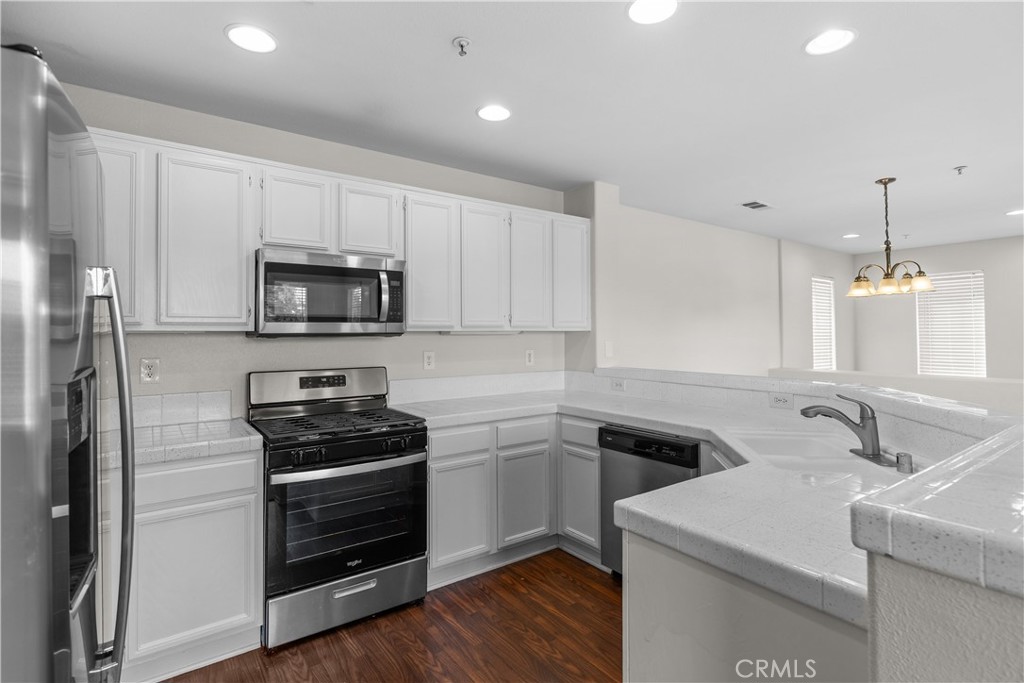 33657 Emerson Way, Unit C Temecula, CA 92592 - Photo 6 of 32 a kitchen that has a sink and a stove top oven