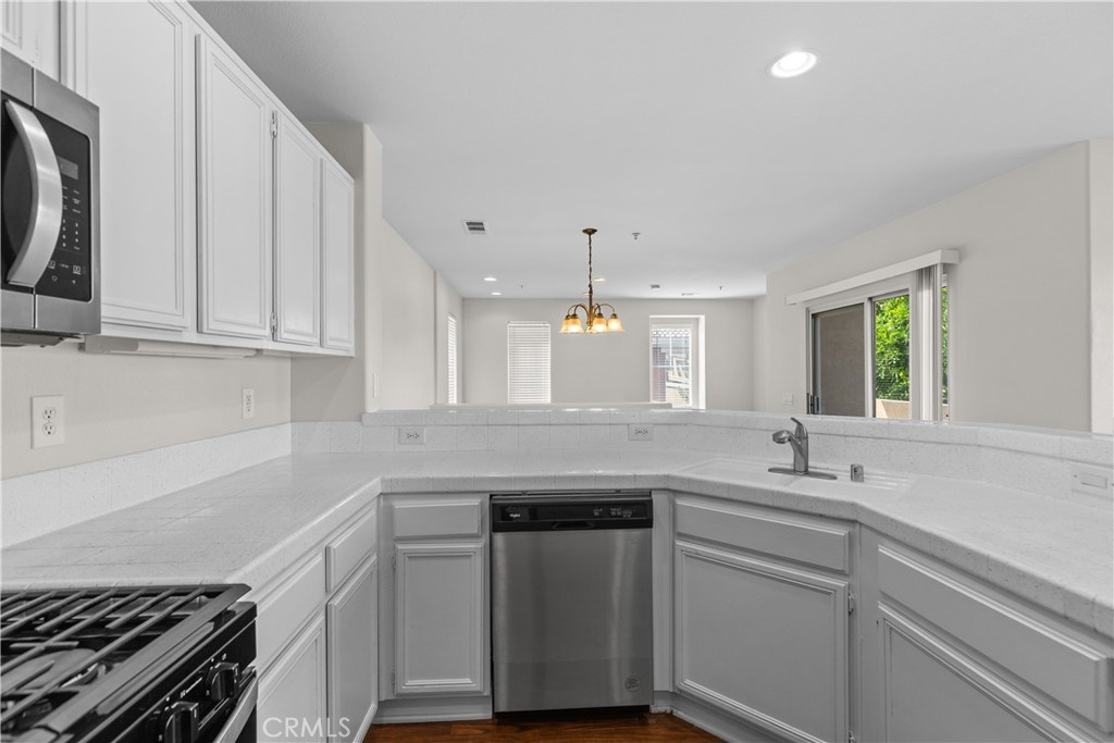 33657 Emerson Way, Unit C Temecula, CA 92592 - Photo 7 of 32 a kitchen with stainless steel appliances granite countertop a sink and a stove