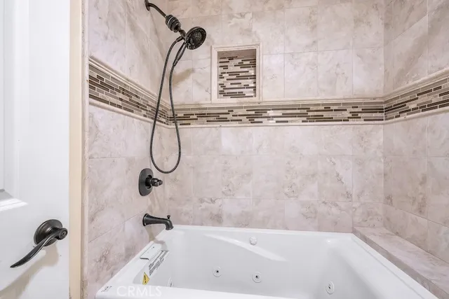 a bathroom with a bath tub and a shower