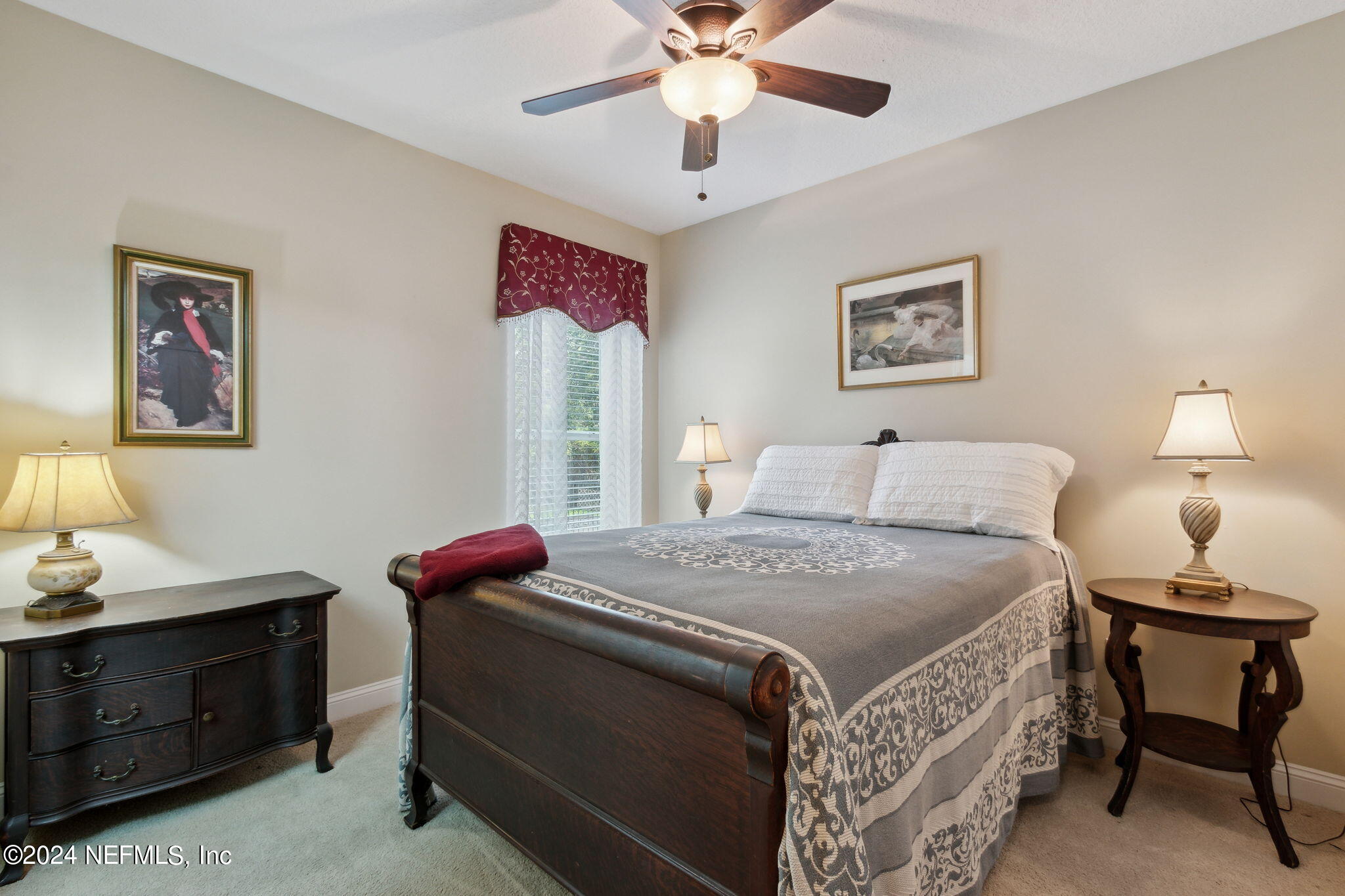 270 Holland Drive St. Augustine, FL 32095 - Photo 26 of 60 a bedroom with a bed and a chandelier