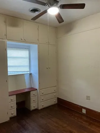 a view of an empty room with closet