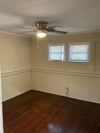 a view of a room with wooden floor
