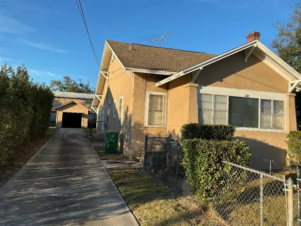a front view of house with deck and yard