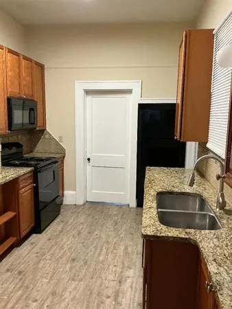 a kitchen with a sink stove and refrigerator