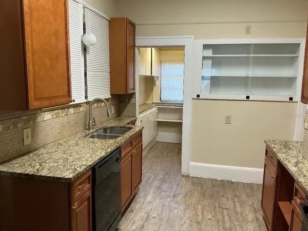 a kitchen with a sink stove and cabinets