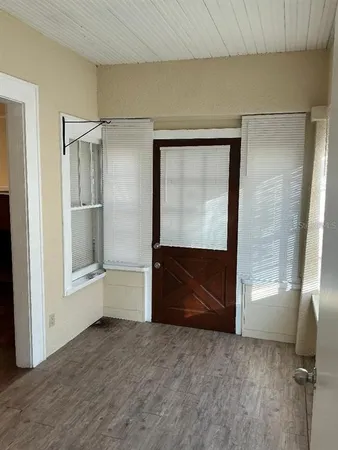 a view of an empty room with a fireplace and cabinet